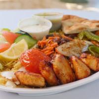 Chicken Tikka Plate · Seven pieces of chicken tikka with rice, salad, raisins, carrots, and bread.