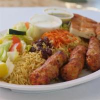 Chicken Kabob Plate · Chicken kabob with rice, salad, raisins, carrots, and bread.