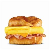 Sunrise Croissant®  · Choice of thinly sliced ham, crisp bacon or sausage topped with folded egg, and American che...
