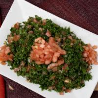 Tabbouli · Vegan. An abundant portion of freshly cut parsley and tomatoes, blended with burghul (cracke...