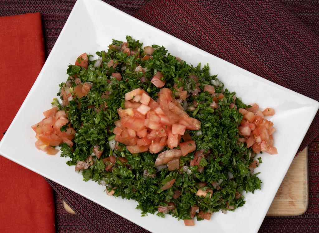 Tabbouli · Vegan. An abundant portion of freshly cut parsley and tomatoes, blended with burghul (cracked wheat) & flavored with lemon juice, olive oil & seasoning.