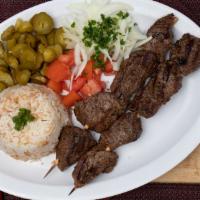 Shish Kebab · Two Shish kabob skewers of tenderloin beef, charbroiled & served with rice & hummus.