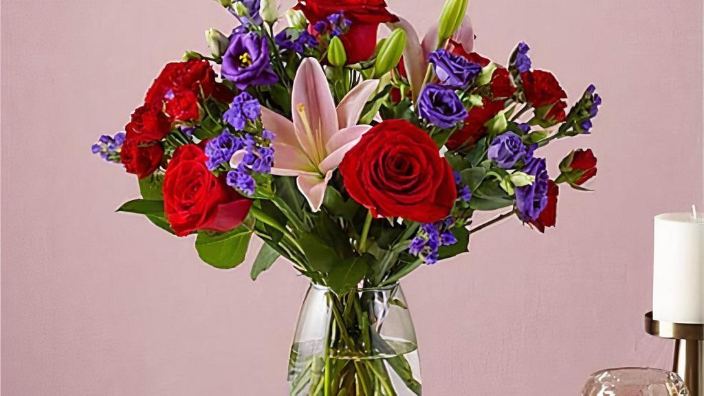 Truly Stunning Bouquet · This dreamy jewel toned bouquet combines bold color and eye catching texture to make a statement. Featuring a thoughtful array of both roses and lilies, this dazzling assortment is bound to impress your recipient. Vase included. Please Note: The bouquet pictured reflects our original design for this product. While we always try to follow the color palette, we may replace stems to deliver the freshest bouquet possible. Item # TSBS