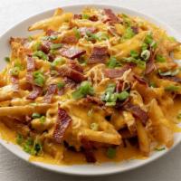 Bacon Cheese Fries · Fries topped with shredded cheddar, smoked gouda, creamy cheese sauce, bacon, and green onio...