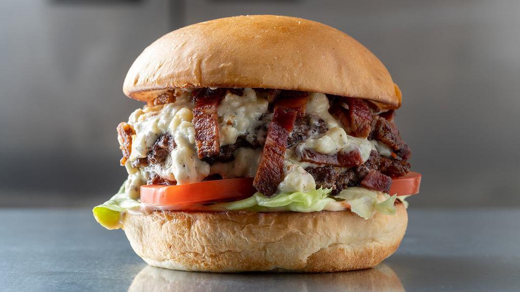 Blue · Bacon, creamy blue cheese, lettuce, tomato, and house burger sauce.
