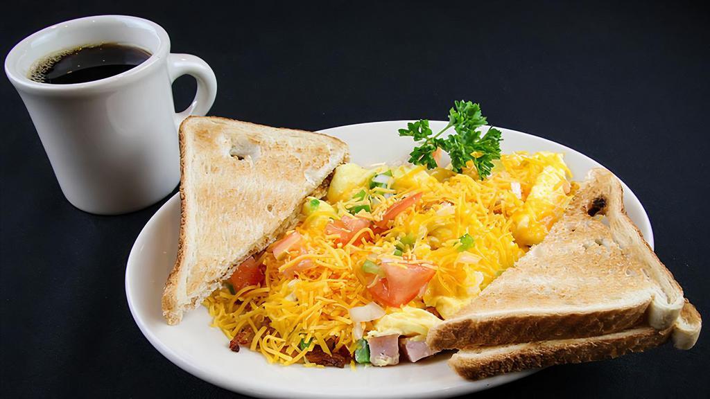 J. Scramble · Crispy hash browns topped with a mixture of scrambled eggs, tomatoes, green peppers, onions, ham and covered with plenty of Cheddar cheese. Served with toast.

Consuming raw or under-cooked meats, poultry, seafood or eggs may pose an increased risk of food-borne illness.