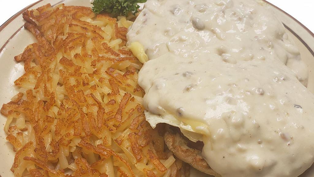 Country Eggs Benedict · A toasted English muffin topped with ham and two eggs cooked to order, hollandaise sauce and our sausage gravy. Served with your choice of potatoes