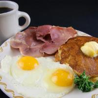 Country Ham & Corn Cake Special · A couple of special tasting pancakes cornmeal style with a slice of country ham and served w...