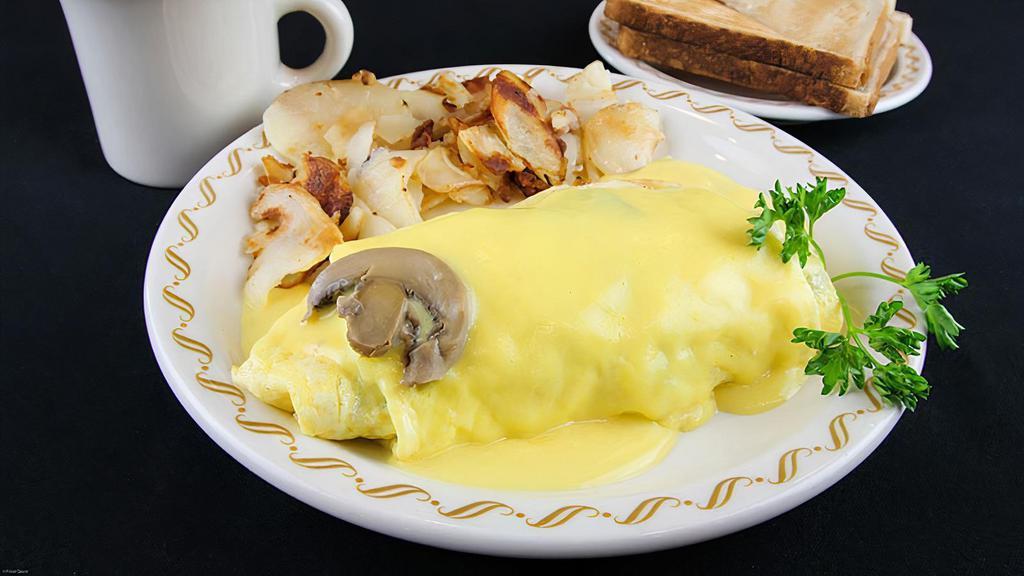 Southern Mushroom Omelette · A country size omelette stuffed with mushrooms, onions and sausage with Monterey Jack & Cheddar cheeses and topped with hollandaise sauce.