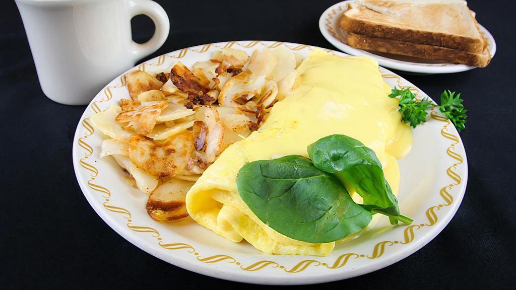 Spinach Omelette · A country size omelette filled with fresh spinach leaves, diced tomatoes, onions, bacon bits and combination of Monterey Jack and Cheddar cheeses and topped with hollandaise sauce.
