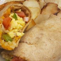 Tj Scramble Wrap · A traditional western mix of scrambled eggs, ham,onions,green peppers, hash browns and chedd...