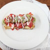 Signature French Toast · Baked custard French bread, kiwis, strawberries, vanilla and strawberry glaze