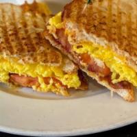 Breakfast Panini · Scrambled eggs, tomatoes, American cheese, and bacon and served with brunch potatoes.