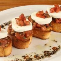 Bruschetta Garlic Bread · Four slices of garlic toasted French bread. Served with fresh chopped tomatoes, basil, roast...