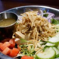 Grilled Chicken Salad · Spring mix, grilled chicken, carrots, thin tortilla strips with honey lime vinaigrette dress...