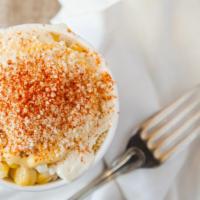 Elote · Sweet corn boiled to perfection and topped with mayonnaise, butter, cotija cheese, and chili...
