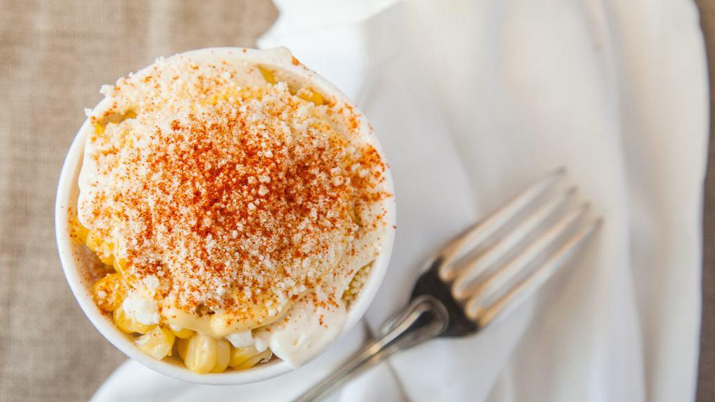 Elote · Sweet corn boiled to perfection and topped with mayonnaise, butter, cotija cheese, and chili powder.