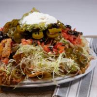 Chili Nachos · Our nachos are piled high on chips with cheese, lettuce,tomatos,olives,jalepenos,sour cream,...