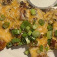 Potato Skins · We take Grade A fresh potatoes and pile on melted cheddar jack, bacon, and green onions. Ser...
