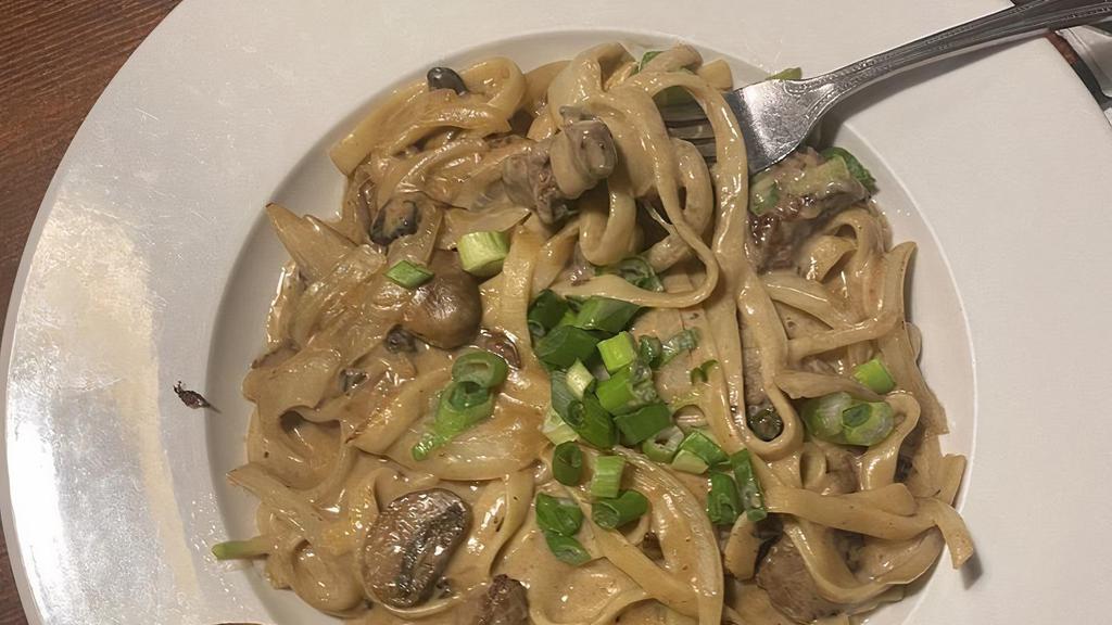 Beef Stroganoff · Fettuccine smothered in strips of beef sauteed in butter with onions, mushrooms and a sour cream and herb sauce.