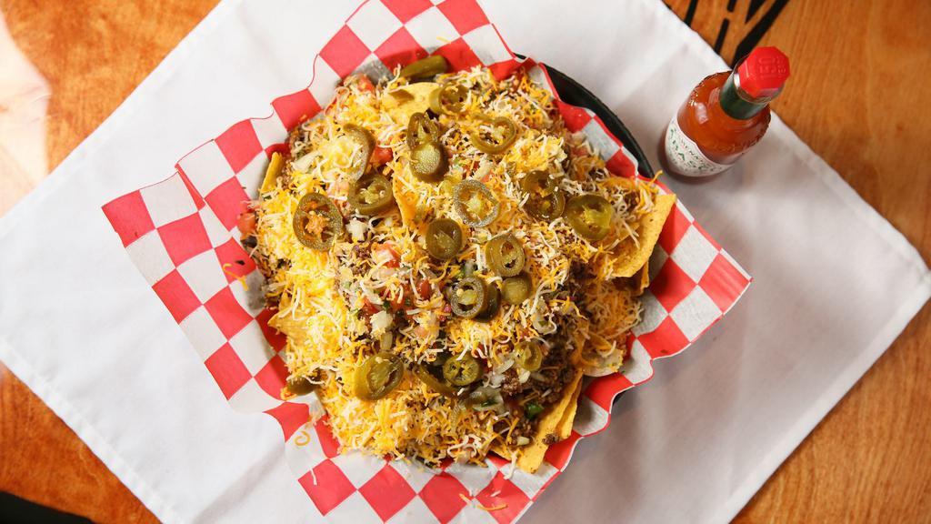 Nacho Platter · CRISPY HOMEMADE CORN TORTILLA CHIPS TOPPED WITH GROUNF BEED OR DICED CHICKED, CHEEDAR CHEESE SAUCE, SLICED JALAPENOS, DICED TOMATOES, CHOPPED ONIONS, SHREDDED CHEESE, SOUR CREAM AND SALSA