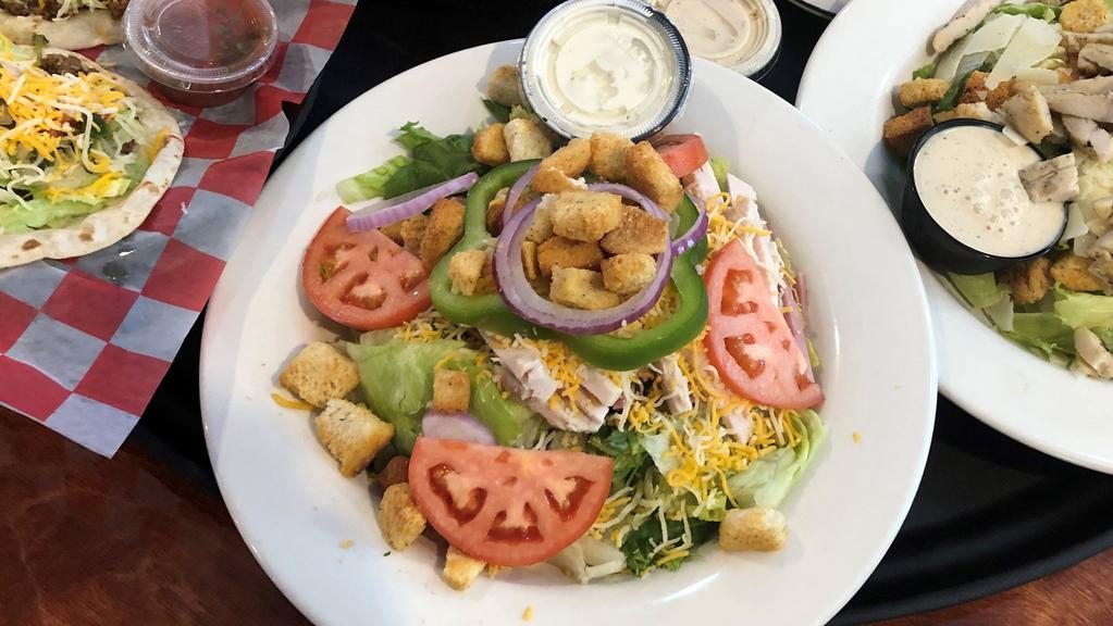 Home Turf Salad · ICEBERG AND ROMAINE LETTUCE TOPPED WITH TOMATO, SLICED CUCUMBER, RED ONIONS, AND  YOUR CHOICE OF DRESSING.