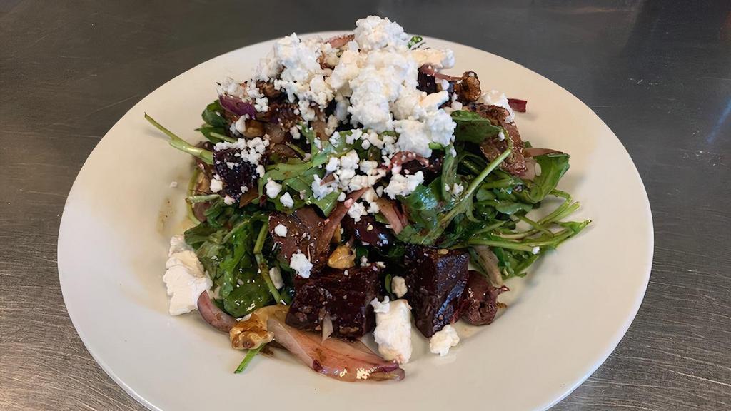 Sm Wood Roasted Beets Salad · roasted beets, arugula, sliced olives, walnuts, red onion, goat cheese, balsamic vinaigrette (This item is gluten free, and can be prepared vegan without the goat cheese)