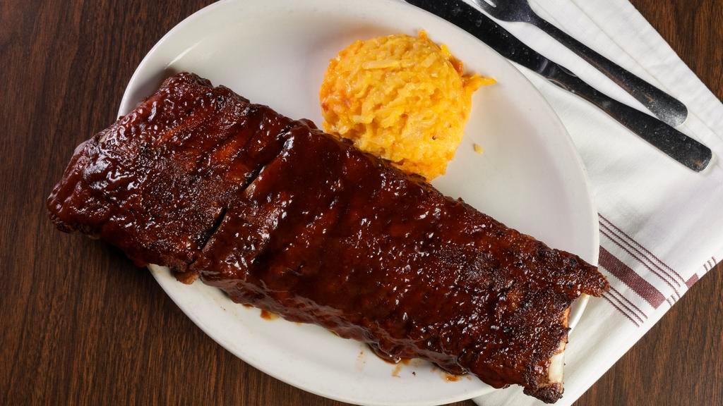 Baby Back Pork Ribs · Slow-cooked and topped with our homemade tangy BBQ sauce. Best around!.