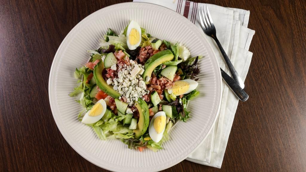 Cobb Salad · Mixed greens, crumbled bleu cheese, hard-boiled egg, tomato, avocado, cucumber, and diced bacon.