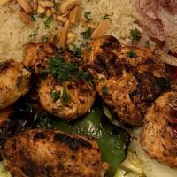 Shish Tawook Sandwich · Chunks of Grilled Tawook Chicken wrapped with onion, pickle, & tomato with Garlic & Tahini s...