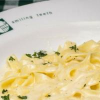 Fettuccine Alfredo · Served with dinner salad and garlic bread.