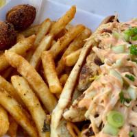 Blackened Chicken Po Boy · With cajun fries and hush puppies.