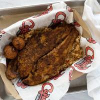 Blackened Fish Fillet · With dirty rice and hush puppies.