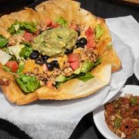 Taco Salad · Freshly made tortilla bowl layered with seasoned beef or chicken, cheddar and Monterey jack ...