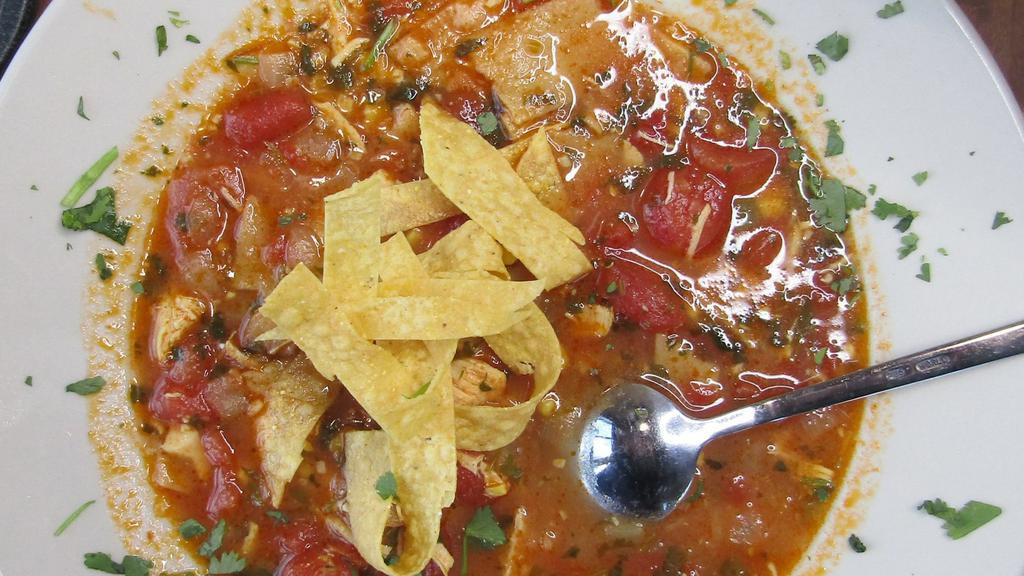 Handmade Tortilla Soup · Made from scratch a savory broth perfectly seasoned with minced garlic, cilantro and our secret blend of spices. Generously filled with morsels of tender chicken breast and diced tomatoes, onions and jalapenos. Topped with crispy tortilla strips.