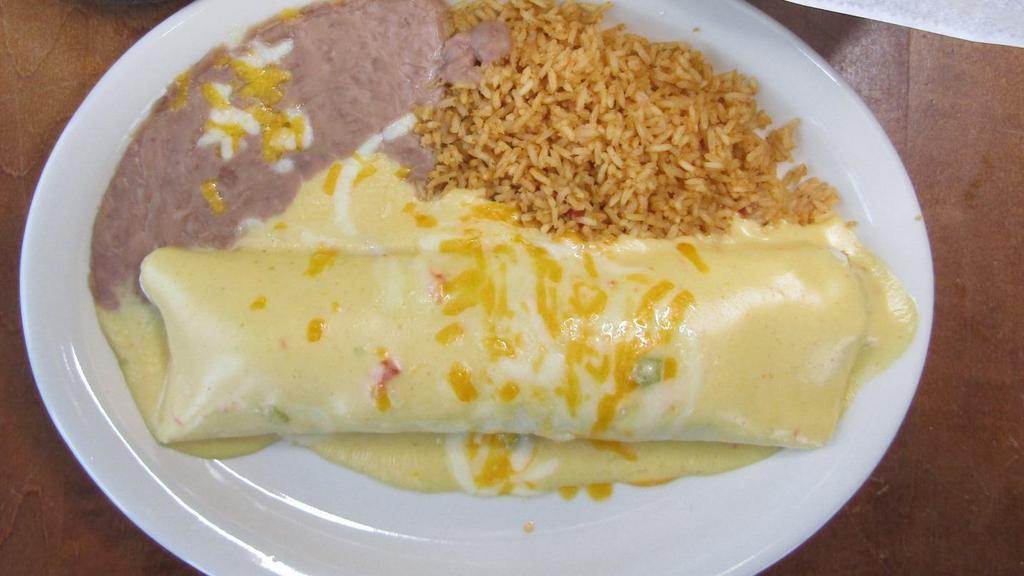 Burrito Dinner · A large 12-inch flour tortilla generously filled with your choice of meat, then topped with melted cheddar and jack cheese. Shredded chicken with rice topped with ground or shredded beef with beans topped with chili sauce or tender pork with beans topped with cream sauce.