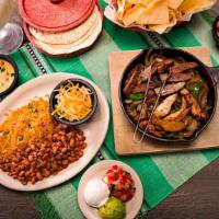Slow Marinated Fajitas · Our slow marinated fajita meat is served in a warm skillet with caramelized onions and bell ...