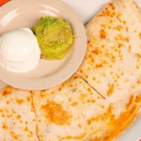 Quesadillas · A large 12-inch flour tortilla, generously filled with our slow marinated fajita meat, diced...