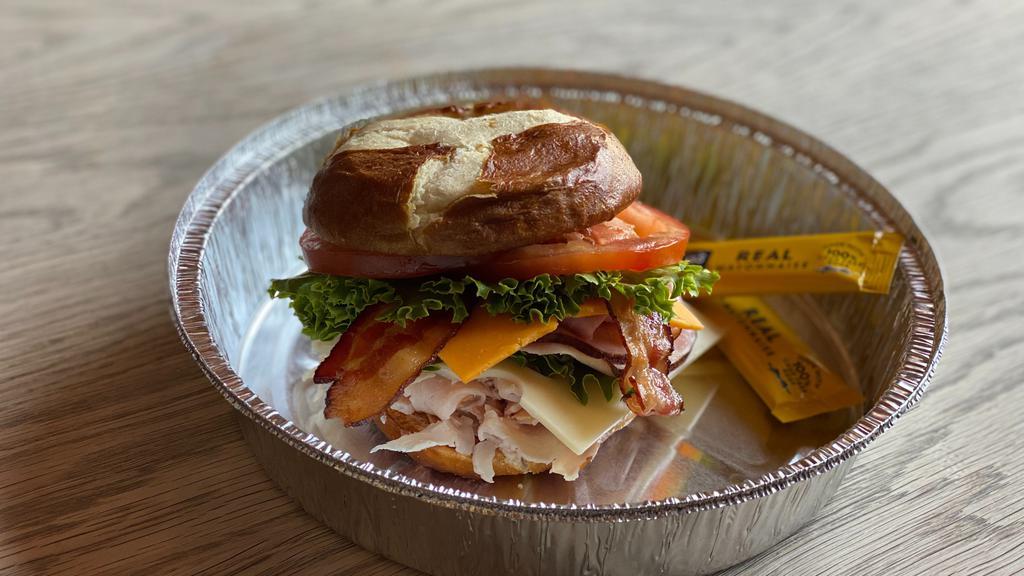 Pretzel Club · Black forest ham, smoked turkey, swiss and thick cut cheddar cheeses, bacon, mayonnaise, lettuce and tomatoes served on a Pretzel Bun.