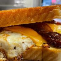 Breakfast Sandwich With Bacon · Toasted egg sandwich – 2 eggs over easy, cheese, bacon on Texas toast