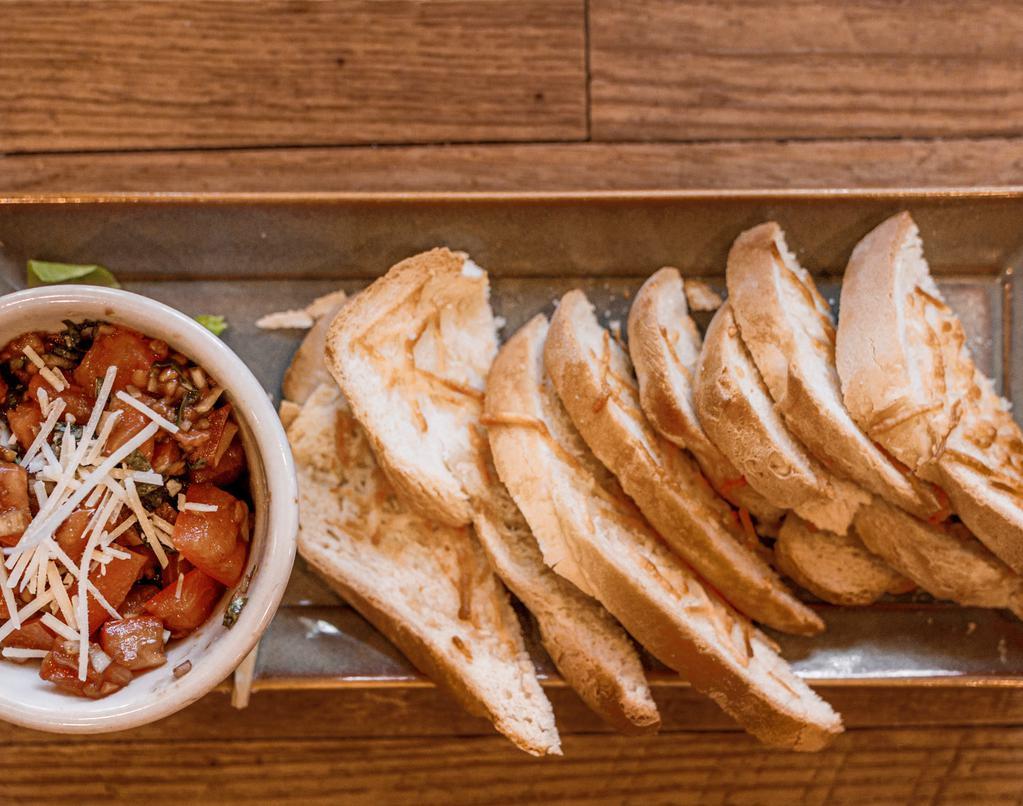 Bruschetta · tomatoes, red onions, garlic, basil and shredded Parmesan all marinated in olive oil and balsamic vinegar. With warm bread