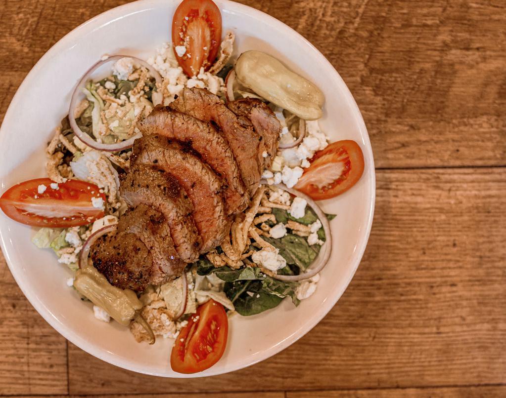 Steak Salad · sliced marinated sirloin with bleu cheese crumbles, roasted red peppers, red onions, and sliced roma tomatoes on romaine with house balsamic dressing. Topped with frizzled onions strings. consuming raw or undercooked meats, poultry, seafood, shellfish or eggs may increase your risk of foodborne illness.