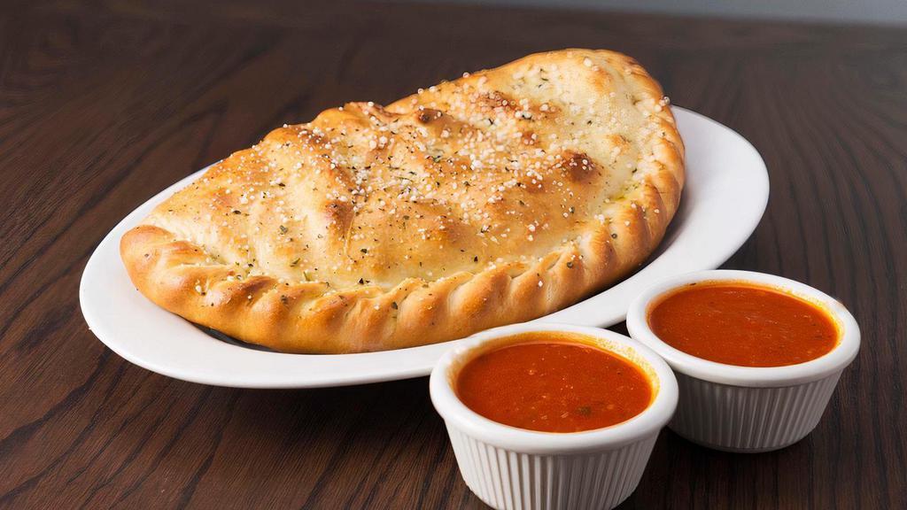 Fresh Cheese Calzone · Oven baked calzones are made from scratch filled with special blend of cheese and served with a side of marinara sauce.