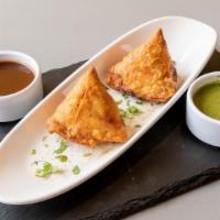Samosa · Minced potato & peas wrapped up in pastry dough and fried.