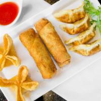 Combo Appetizer · A crispy collection of two Chicken Egg Rolls, two Crab Rangoon Wontons, and four Deep Fried ...