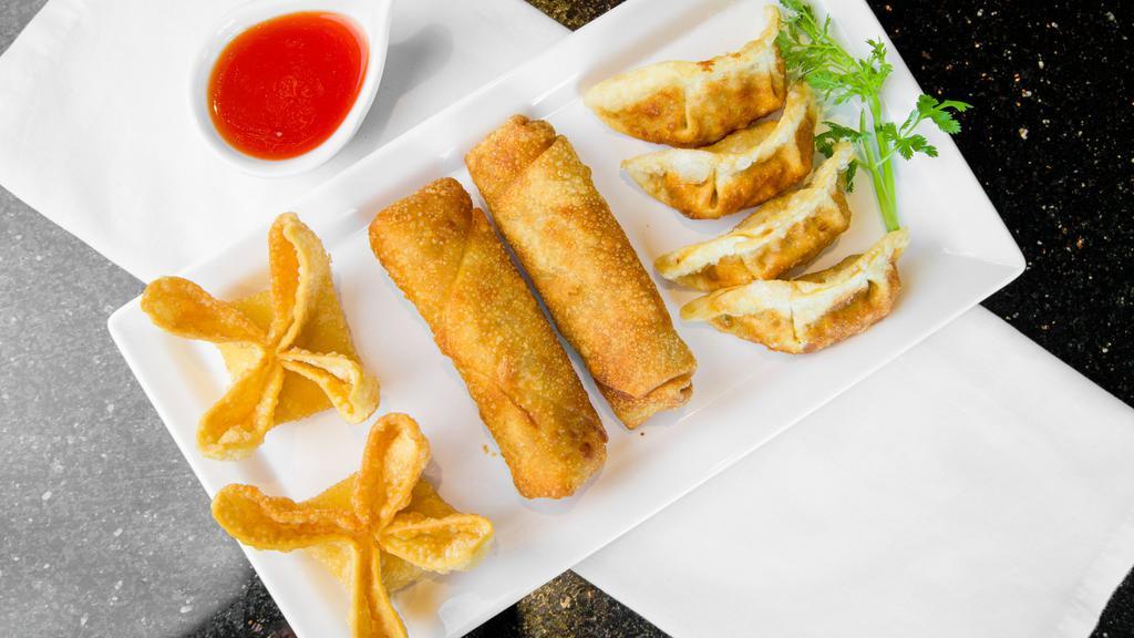 Combo Appetizer · A crispy collection of two Chicken Egg Rolls, two Crab Rangoon Wontons, and four Deep Fried Pot Stickers.