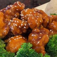 Sesame Chicken · Hand-battered, twice deep-fried chicken in a savory-sweet sauce on a bed of steamed broccoli.