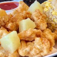 Sweet & Sour Chicken · Crispy, deep-fried chicken with pineapple pieces, served with a side of sweet and sour sauce.