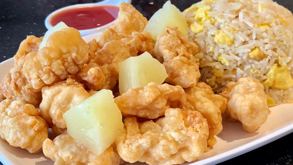 Sweet & Sour Chicken · Crispy, deep-fried chicken with pineapple pieces, served with a side of sweet and sour sauce.
