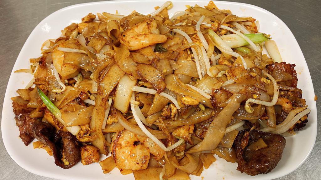 Kway Teow · Malaysian stir-fry flat rice noodles with eggs, onions, scallions, beansprouts, chicken, beef & shrimp.